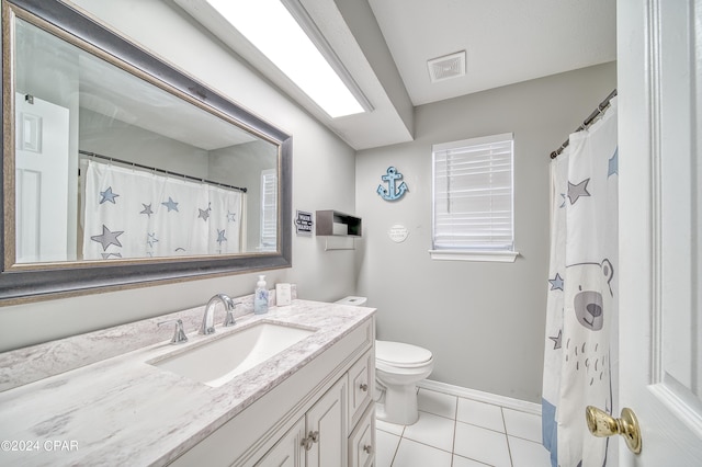 bathroom featuring toilet, vanity, baseboards, visible vents, and tile patterned floors