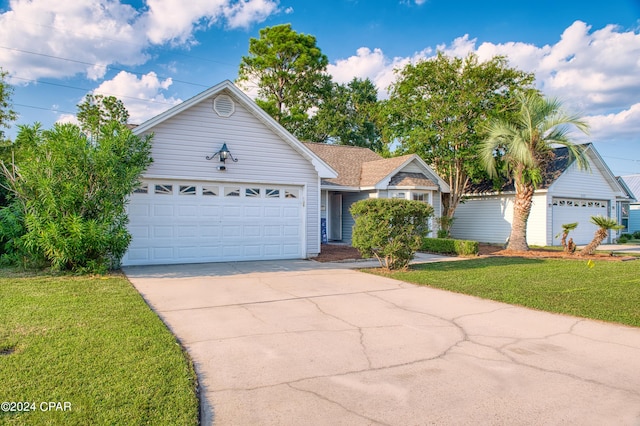 ranch-style house featuring a garage and a front lawn