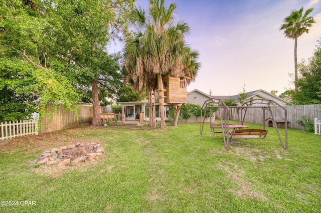 yard at dusk with a fenced backyard