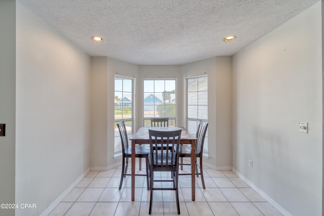 dining room with light tile patterned floors, baseboards, and recessed lighting