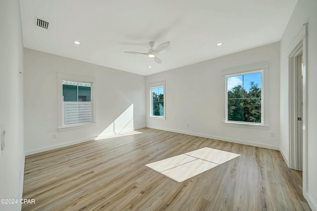 spare room with ceiling fan and light hardwood / wood-style flooring