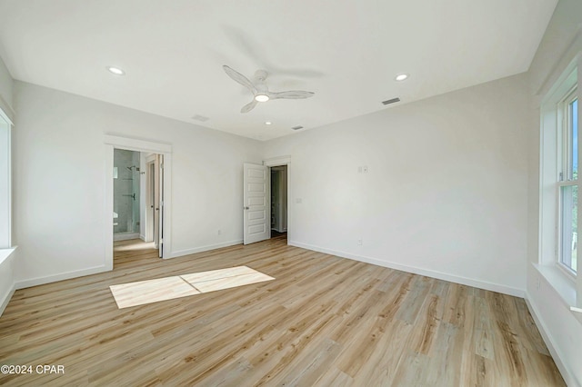 unfurnished bedroom featuring ceiling fan, connected bathroom, and light wood-type flooring