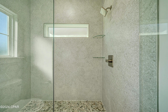 bathroom with a tile shower