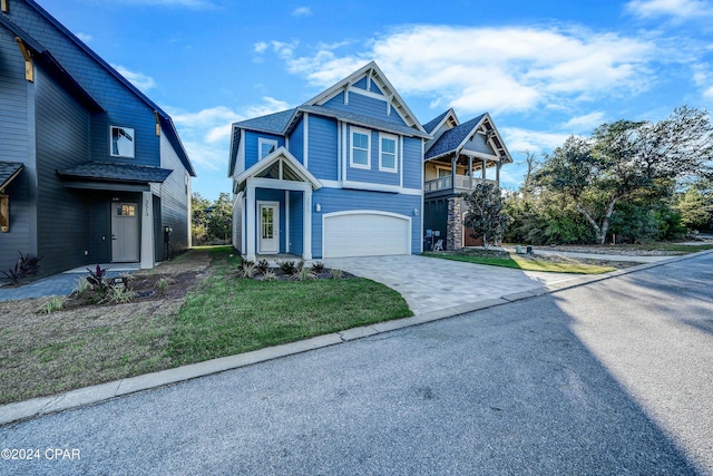 view of front of property featuring a garage and a front lawn