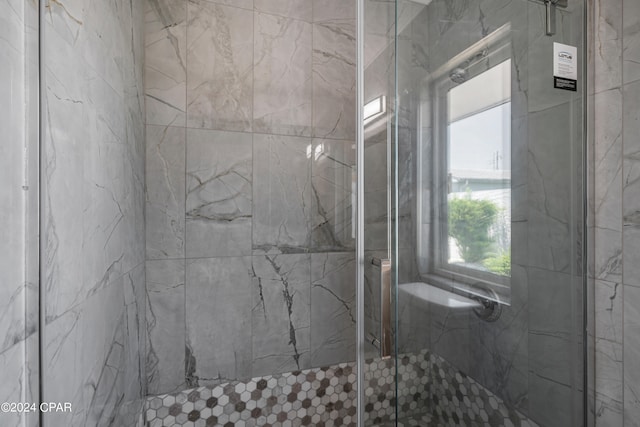 bathroom featuring a shower with door