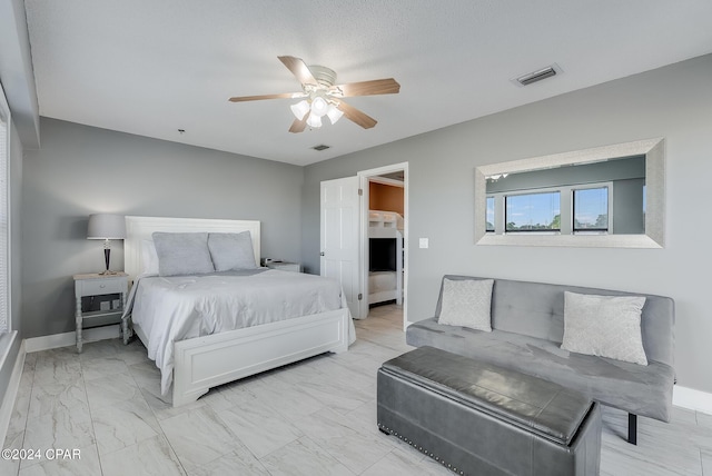 bedroom with marble finish floor, visible vents, and baseboards