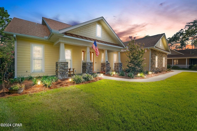 craftsman-style home with a lawn