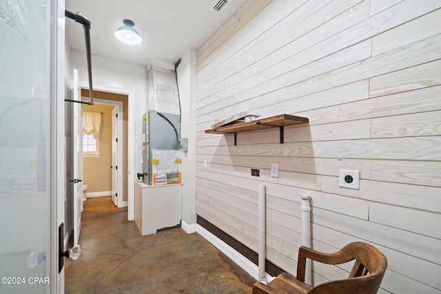 washroom featuring wood walls