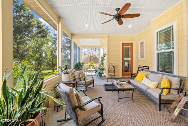 sunroom / solarium featuring ceiling fan and a wealth of natural light