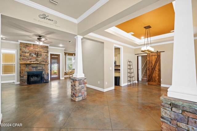 living room with ornate columns, ornamental molding, a fireplace, and ceiling fan