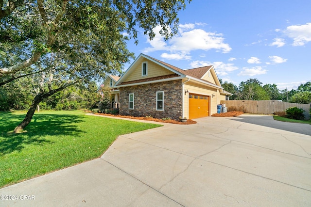 view of home's exterior featuring a garage and a lawn