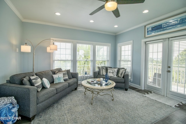 living area featuring a healthy amount of sunlight, crown molding, and wood finished floors