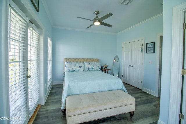 bedroom featuring ceiling fan, baseboards, crown molding, and wood finished floors