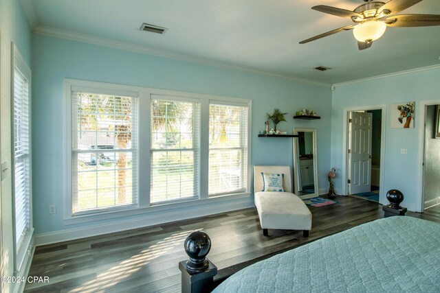 bedroom featuring ceiling fan, multiple windows, crown molding, and dark hardwood / wood-style floors