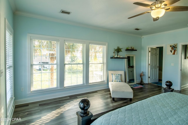 bedroom featuring ornamental molding, wood finished floors, visible vents, and baseboards