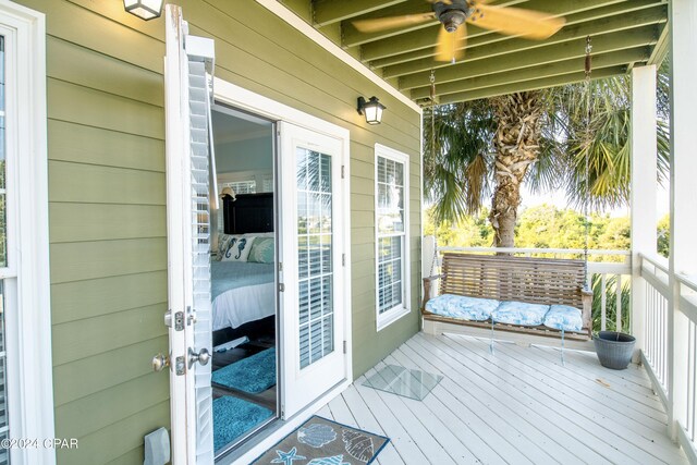 wooden terrace featuring ceiling fan