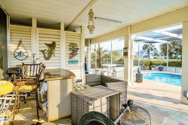 view of patio / terrace featuring glass enclosure and a fenced in pool