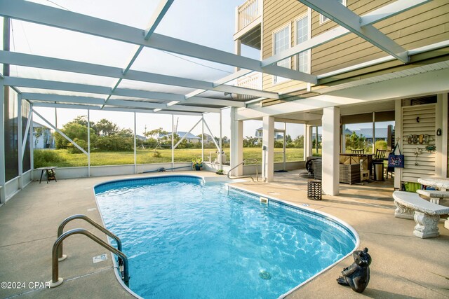 view of swimming pool featuring glass enclosure and a patio area