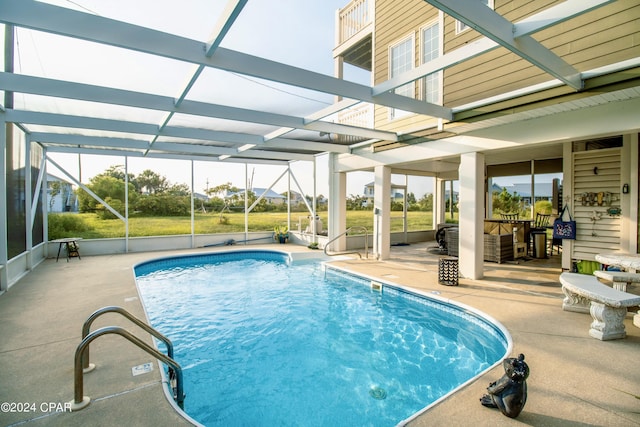 pool with glass enclosure and a patio