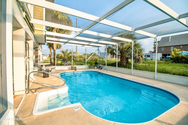 view of swimming pool featuring a patio area and a lanai