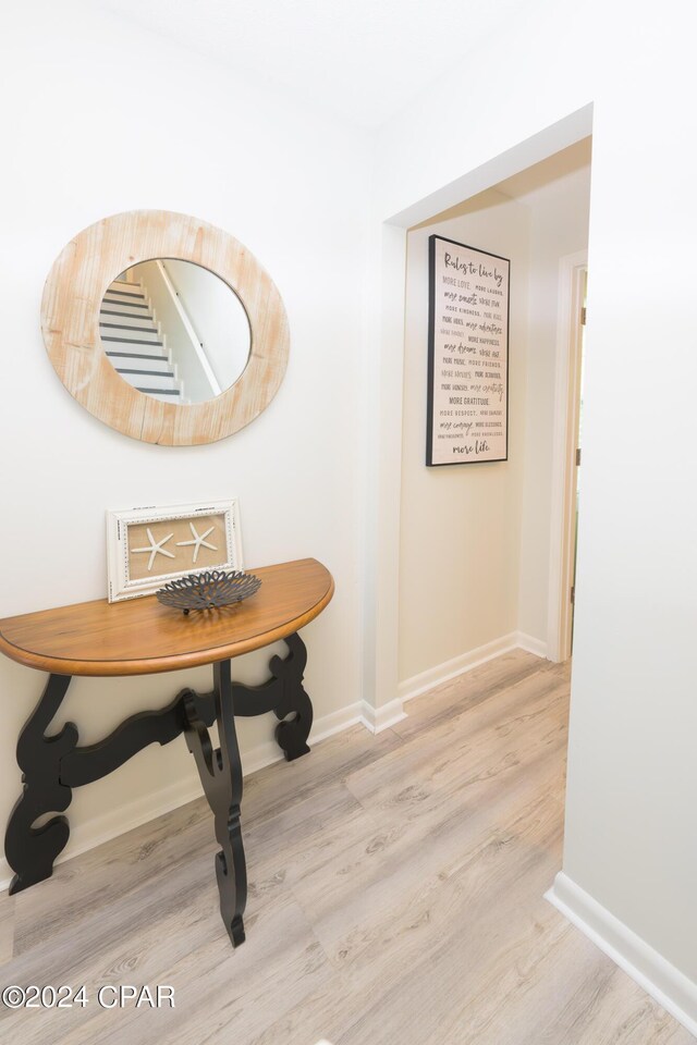 corridor with light hardwood / wood-style flooring