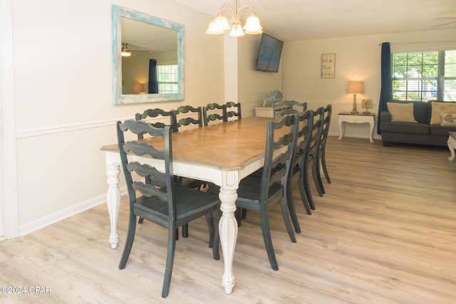 dining area featuring light hardwood / wood-style flooring and a chandelier