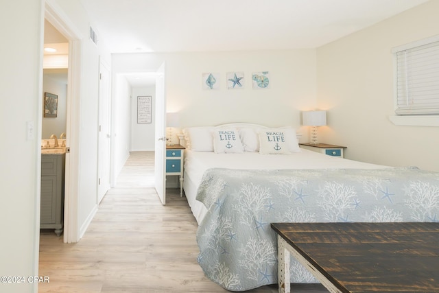 bedroom featuring wood-type flooring and sink