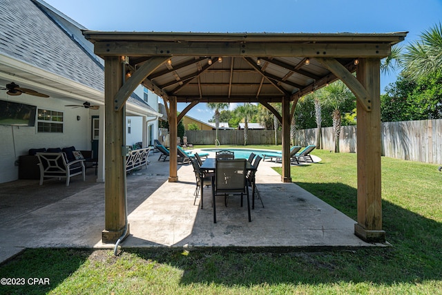 view of patio / terrace with ceiling fan, a gazebo, and a fenced in pool