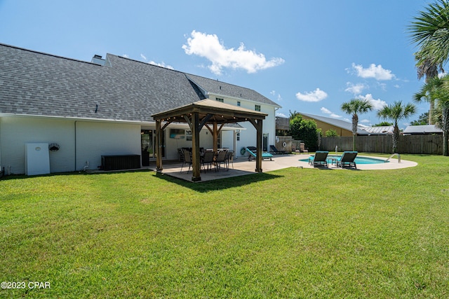 back of house with a fenced in pool, a gazebo, a lawn, and a patio