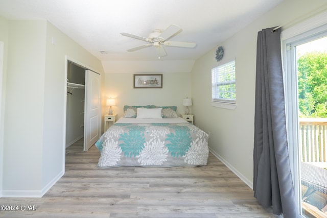 bedroom featuring ceiling fan, multiple windows, a closet, and light hardwood / wood-style flooring