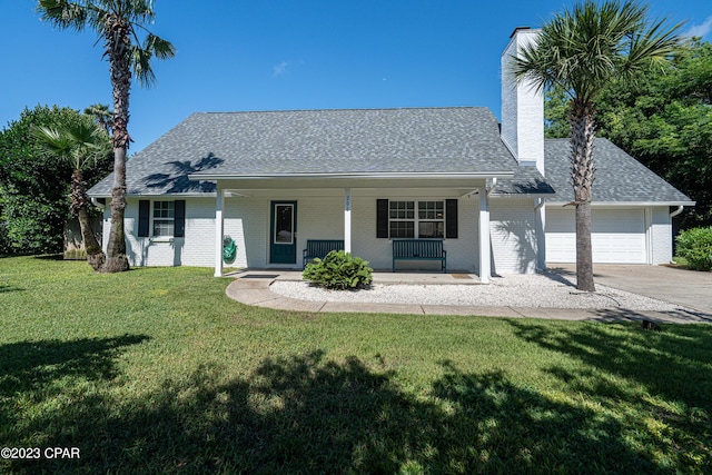 view of front of home featuring covered porch, a front lawn, and a garage