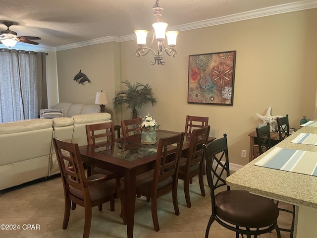 tiled dining room featuring ceiling fan with notable chandelier, ornamental molding, and a textured ceiling