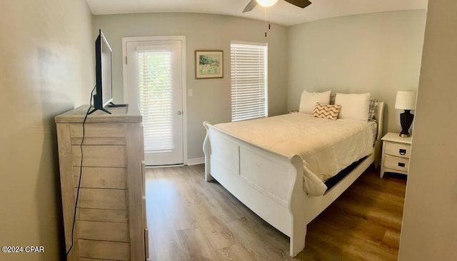 bedroom featuring dark wood-type flooring, ceiling fan, and access to outside