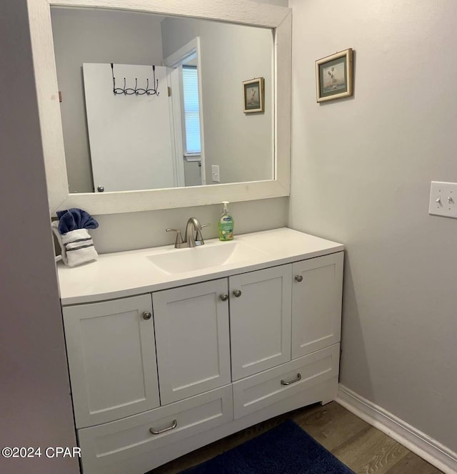 bathroom with hardwood / wood-style flooring and vanity