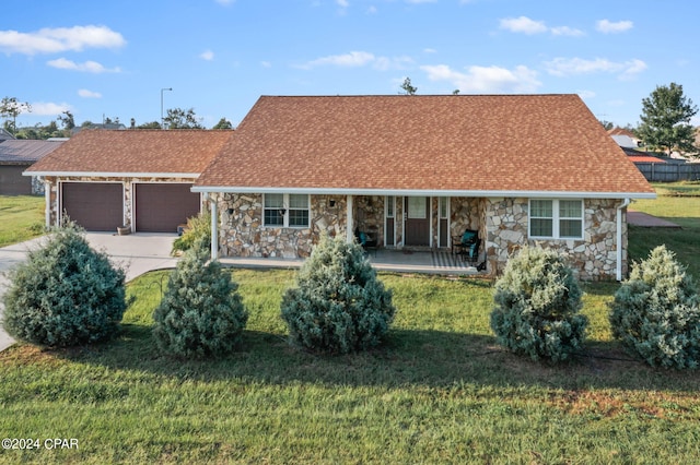 view of front of house with a front yard and a garage