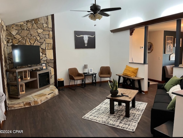 living room featuring dark wood-type flooring, ceiling fan, lofted ceiling, and a fireplace