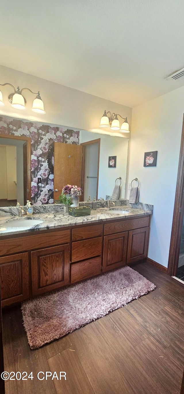 bathroom with vanity and hardwood / wood-style flooring