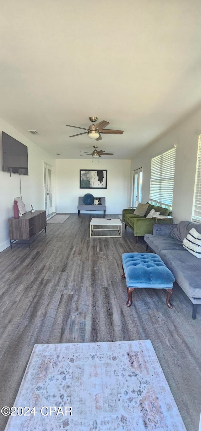 living room with hardwood / wood-style floors and ceiling fan