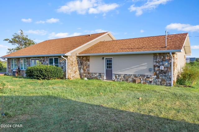 rear view of property with a yard