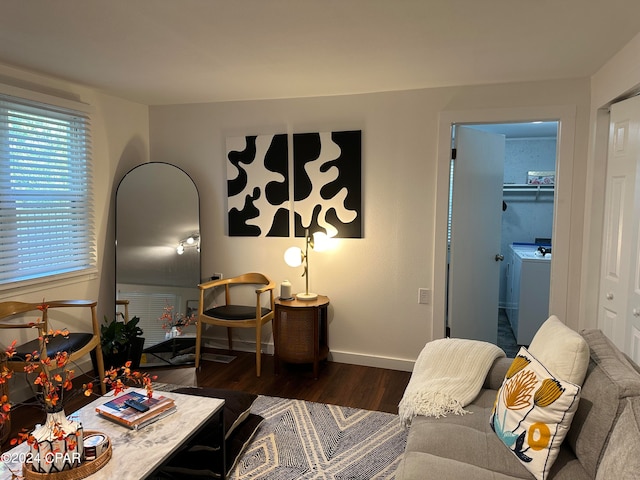 living room with dark hardwood / wood-style floors and washer / dryer