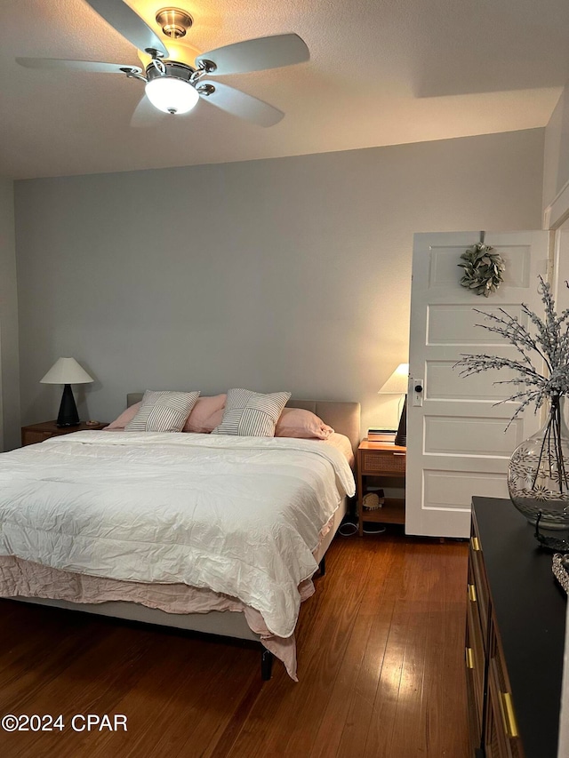 bedroom featuring ceiling fan and dark wood-type flooring