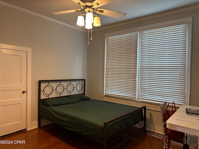 bedroom with ceiling fan, crown molding, and dark wood-type flooring