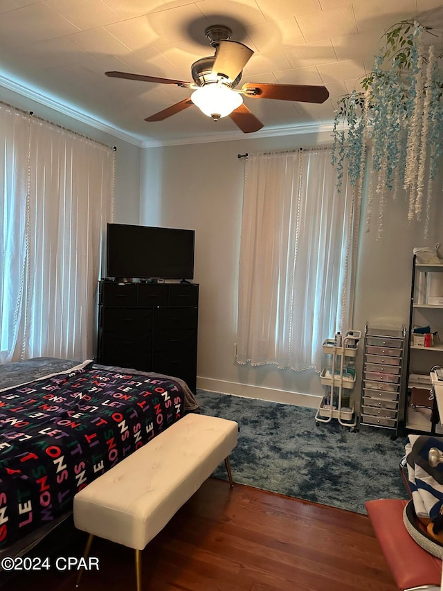 bedroom featuring ceiling fan, hardwood / wood-style floors, and ornamental molding