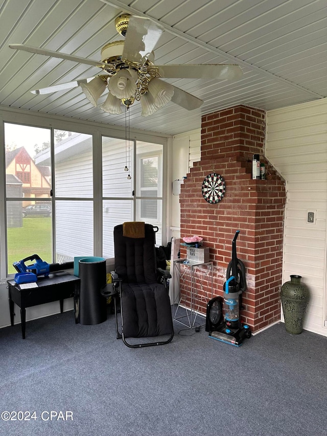 sunroom / solarium featuring ceiling fan