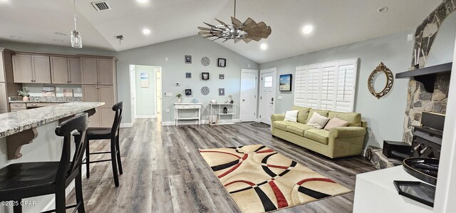 kitchen with dishwashing machine, washer / dryer, high end black refrigerator, and dark hardwood / wood-style floors