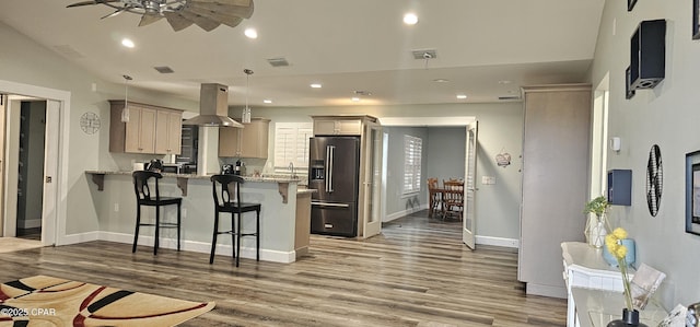 kitchen featuring stone countertops, black range with electric cooktop, ventilation hood, and dark hardwood / wood-style floors