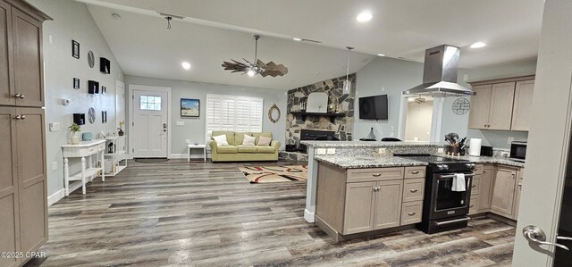 kitchen with sink, high end black refrigerator, light wood-type flooring, dishwashing machine, and island exhaust hood