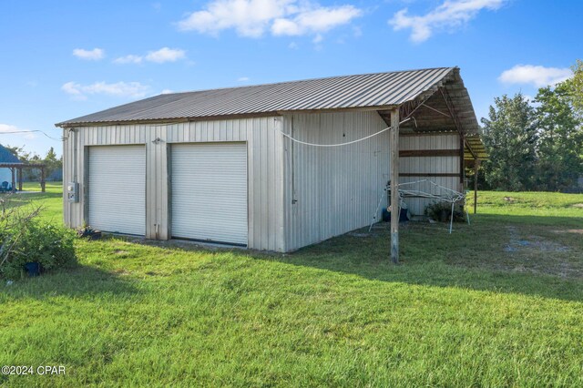 view of outdoor structure with a garage and a yard