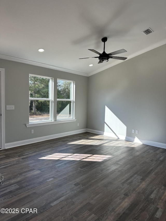 unfurnished room with crown molding, visible vents, baseboards, dark wood finished floors, and a ceiling fan