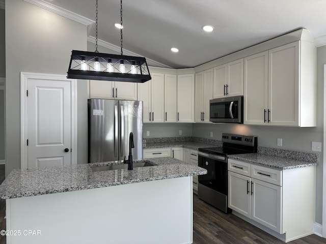 kitchen with stainless steel appliances, a kitchen island with sink, white cabinets, light stone counters, and sink